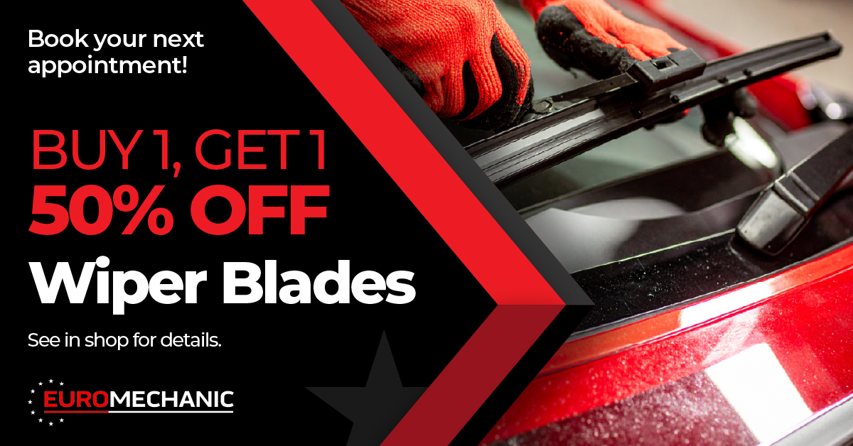 A close-up of hands replacing a windshield wiper blade on a red car. Text promotes a “Buy 1, Get 1 50% Off Wiper Blades” offer at Euromechanic, encouraging customers to book an appointment. EuroMechanic - McNally Auto | Top Reviewed Auto Repair Shop in North York | Visit EuroMechanic - McNally Auto